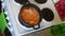 The meatballs in the boiling sauce stand on the stove, the man removes the lid from the pan.