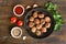 Meatballs in cast iron pan, fresh parsley and tomatoes