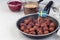 Meatballs in frying pan, served with cream sauce and cranberry jam, swedish flag, horizontal, copy space