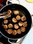 Meatballs Frying in Pan with Stainless Steel Tong