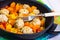 Meatballs poultry with pumpkin and orange in pan on white wooden