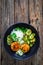 Meatballs served with white rice and marinated sliced cucumber on wooden background