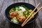 Meatballs served with white rice and marinated sliced cucumber on wooden background