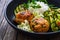 Meatballs served with white rice and marinated sliced cucumber on wooden background