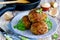 Meatballs stuffed with boiled eggs and green herbs butter