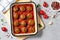 Meatballs in Tomato Sauce, Homemade Meatballs in a Baking Dish on Bright Concrete Background