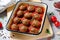 Meatballs in Tomato Sauce, Homemade Meatballs in a Baking Dish on Bright Concrete Background