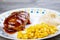 Meatloaf dinner with corn and potatoes served on a plate