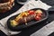 Meatloaf with french fries and vegetables on a wooden board, traditional English food. Food photo, copy space.