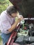 Mechanic Adding Engine Coolant To Customers Vehicle