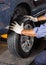 Mechanic Adjusting Car Tire