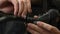 Mechanic assembles road bicycle, close up of hands. Man fixing brakes on bicycle with wrench