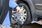 Mechanic attaching the wheel alignment device onto the wheel at workshop