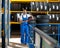 Mechanic in blue uniform standing at stock tyre