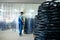 Mechanic carries bicycle wheels on a cart, factory