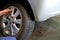 Mechanic change car wheel in auto repair shop. serviceman replac