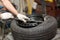 Mechanic changing car tire fitting. Wheel tyre repairing.