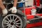 Mechanic changing car tire fitting. Wheel tyre repairing.