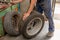 Mechanic changing tire in car service. Tire rotation machine.Car mechanic mounts tire on wheel in a workshop