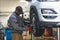 Mechanic changing tyre using an electric wrench car is lifted for smooth process