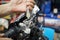 Mechanic Check and use syringe to transfer and Add Brake Fluid,in garage, motorcycle maintenance and service and repair concept