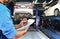 Mechanic checks the engine repair list at the garage.
