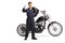 Mechanic with a chopper carrying a motorbike tire and showing thumbs up