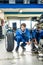 Mechanic Crouching While Changing Car Tire At Garage