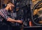 Mechanic cutting and polish bicycle part in a workshop.