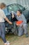 Mechanic discussing accident damage on car with customer