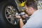 Mechanic Fixing Bolts With Electronic Fitter