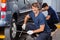 Mechanic Fixing Car Tire At Auto Repair Shop