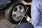 Mechanic Fixing Car Tire With Rim Wrench