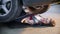 mechanic girl lying under the car and reaching for the spanner, smiling