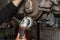 A mechanic grinds, with an angle grinder, the edge of an old rear brake disc in a car, regeneration of the brake system.
