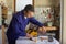 mechanic in his garage repairing a chainsaw by tensioning the chain. Do-it-yourself work in anticipa