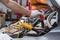 Mechanic holding car battery repair jumper wires in maintenance center