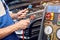 Mechanic holds a set of high-pressure pipes for filling the car`s air conditioning system. A/C Manifold Gauges Set