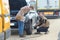 mechanic inflating womans car tyre roadside