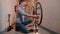 A mechanic inspects a bicycle in a workshop.