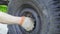 Mechanic installs a wheel on an old truck, close-up