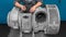 A mechanic maintains a marine turbocharger. Engineer repairs equipment. Turbine close-up.