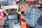 Mechanic male in automobile garage processing diagnostic