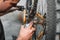 Mechanic man Hands, Spraying Oil To A Bike Chain. Bicycle maintenance.