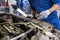 Mechanic man with pliers repairing car at workshop