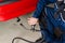 Mechanic measuring exhausts of a car in garage