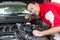 A Mechanic Pouring Brake Fluid Into A Master Cylinder