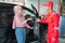 Mechanic in red receives the car keys from the customer before the car is repaired