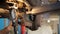 Mechanic repair brakes in garage of repair service station.