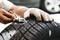 Mechanic repair a tire puncture from a nail or screw. car repair and maintenance concept